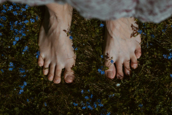 Barefoot on grass, free and connected to the earth