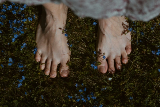 Healthy bare feet on natural grass after a barefoot run