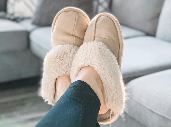 Bare feet on a warm wooden floor at home
