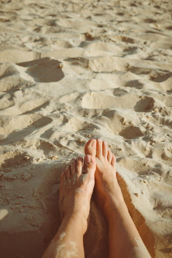 Clean bare feet on sand showing healthy natural barefoot skin