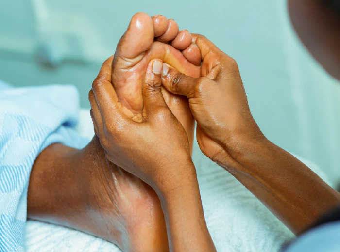 Hands massaging bare feet