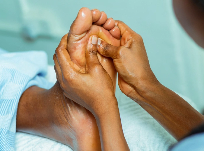 Hands massaging bare feet