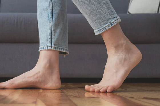 Person walking barefoot at home
